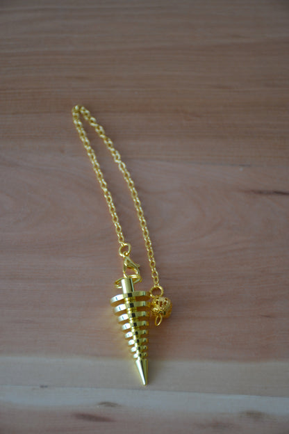Péndulo espiral dorado